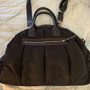 Sol and Selene black puffer bag over shoulder
